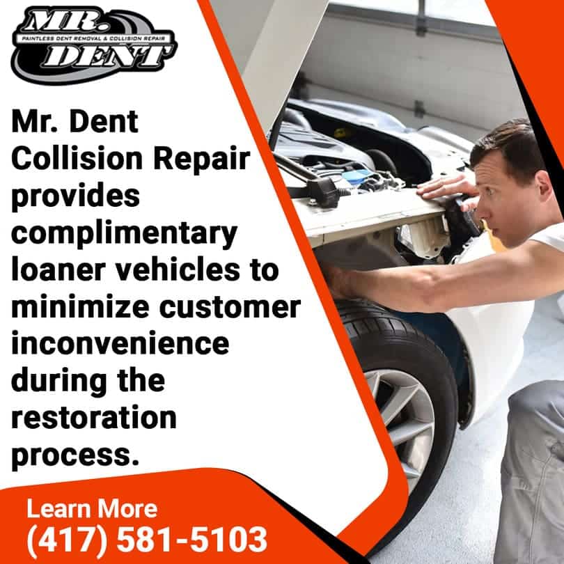 Auto body technician inspecting the front end of a white vehicle inside a repair shop, representing Mr. Dent Collision Repair’s commitment to convenience with complimentary loaner cars during service.